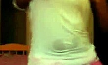 Exotic ebony woman dances and poses in shorts on webcam, showcasing her fabulous designer outfit.