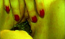 Tattooed guy toys cute brunette's tight pussy