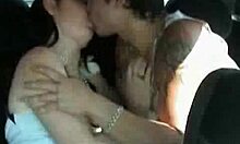 inked guy making out with cute girl during car ride