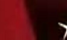 dirty cheap prostitute posing seductively on her huge red bed