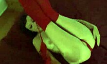 dirty cheap prostitute posing seductively on her huge red bed