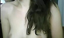 this marvelous petite brunette vixen is doing naughty things with her big tits on webcam