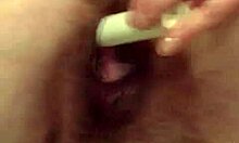 A married woman in stockings masturbates with anal toys, showing her hairy pussy.