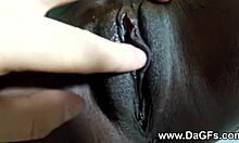 Ebony teen with tattoo and piercing shows shaved pussy close-up