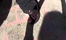 Girl With Stylish Hat Pees Between Trash Cans