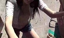 Girl With Stylish Hat Pees Between Trash Cans