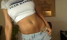 Hot babe with big tits and piercing dances in miniskirt and panties for cam