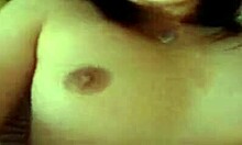 Asian woman spreads firm tits for webcam masturbation