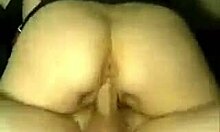 a woman lies in bed touching herself gently