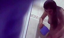 brown-haired cutie inspecting her big boobies while standing in bathroom