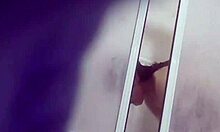 brown-haired cutie inspecting her big boobies while standing in bathroom