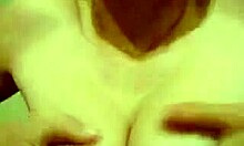 cheerful gal proudly displaying her cute features in the mirror