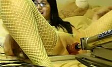 Watch this nerdy brunette in fishnets get fucked by a machine? She's loving it!