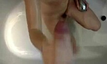 horny teen can't resist stroking a big cock in the steamy bath.