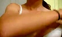 cheerful gal proudly displaying her cute features in the mirror