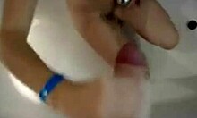 horny teen can't resist stroking a big cock in the steamy bath.