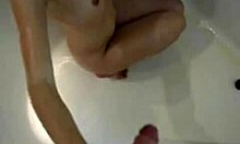 horny teen can't resist stroking a big cock in the steamy bath.