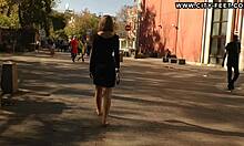 Blonde walks barefoot on streets.