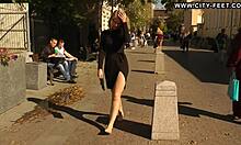 Blonde walks barefoot on streets.