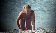 Curly-haired chick in shades dripping wet on hidden beach cam