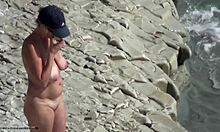 blonde with natural breasts showing off her body on a beach!