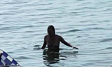 Small-breasted blonde poses on nudist beach.