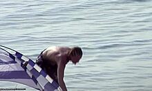 Small-breasted blonde poses on nudist beach.