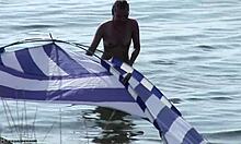 Small-breasted blonde poses on nudist beach.