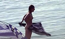 Small-breasted blonde poses on nudist beach.