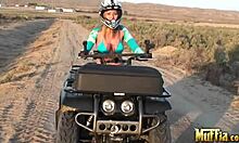 two blonde lesbians ride atvs half-naked, licking in desert