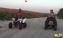 two blonde lesbians ride atvs half-naked, licking in desert