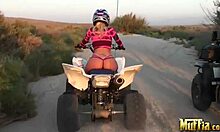 two blonde lesbians ride atvs half-naked, licking in desert