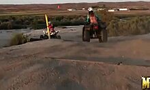 two blonde lesbians ride atvs half-naked, licking in desert