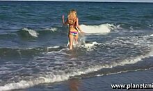 extremely sexy blond posing half-naked on the shore intrigues with softcore allure