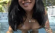 She strips by the pool, showing off her round booty.