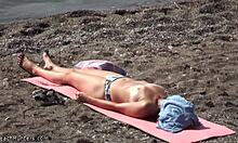 Topless hottie in panties sunbathes shamelessly on public beach