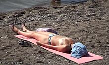 Topless hottie in panties sunbathes shamelessly on public beach