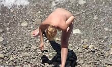 Blond-Haired Bombshell Shows Naked Body On Rocky Beach