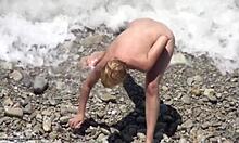 Blond-Haired Bombshell Shows Naked Body On Rocky Beach