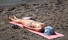 Topless hottie in panties sunbathes shamelessly on public beach