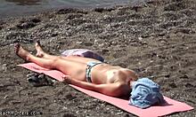 Topless hottie in panties sunbathes shamelessly on public beach