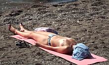 Topless hottie in panties sunbathes shamelessly on public beach