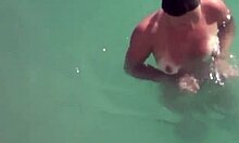 tanned brunette skinny dips naked on cam showing big tits