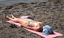 Topless hottie in panties sunbathes shamelessly on public beach