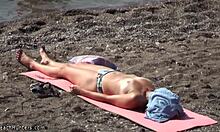 Topless hottie in panties sunbathes shamelessly on public beach