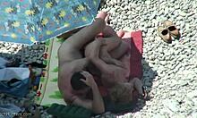Sideways sex with a blond-haired babe on a sunny beach under hidden cam