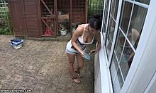 damn, this tanned brunette flashes her big tits outside