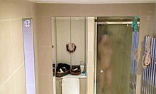 showering brunette showcases her beautiful pale breasts on cam