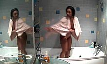 Slim brunette bathes naked in bathroom