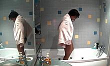 Slim brunette bathes naked in bathroom